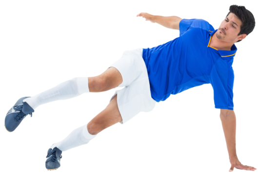 Digital png photo of biracial male footballer kicking on transparent background
