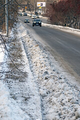 Uncollected snow by the side of the road on a winter day