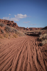 Sandy wash in Utah desert landscape with dirt bike tracks