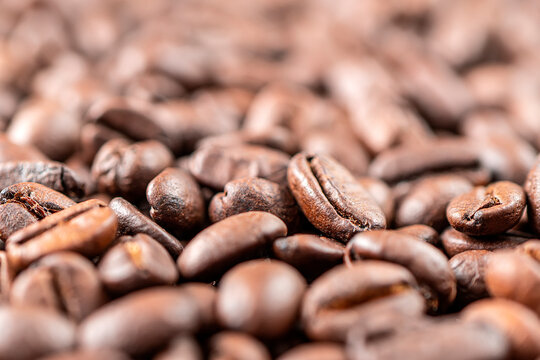 Closeup macro group roasted brown or black coffee grains background