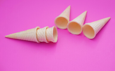 Empty crispy waffle ice cream cones isolated on pink background. Concept, part of pattern of ice...