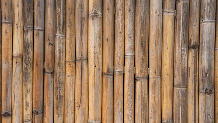 Bamboo cylinders lined up next to each other It's a room wall. Light brown tone It's a natural...