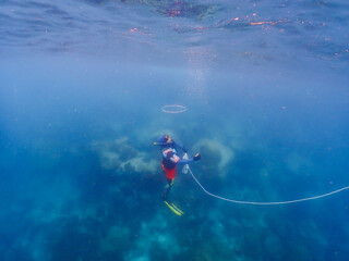young men at a snorkeling trip in Samaesan Thailand. dive underwater with fishes in the coral reef sea pool. Travel lifestyle, watersport adventure, swim activity on a summer beach holiday 