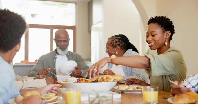 Happy, black family and kids in home for lunch, supper and eating meal at table together. Grandparents, parents and hungry children with food for bonding, relax and talking in dining room for event