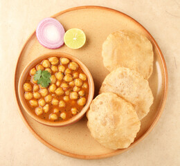 Indian food, spicy Chick Peas Curry also known as Chola/Chana Masala or Chole, served with fried puri or poori