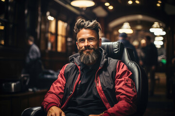 Obraz premium A smiling bearded man sitting in a barber shop, looking trendy and relaxed with a stylish haircut.