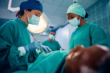 Female surgical team during operation in hospital.