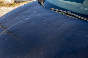 hail car hood black damaged by hailstorm hailstone dented car grey dark bonnet - obrazy, fototapety, plakaty