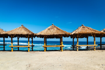 beach hut looking over the ocean on sandy beach in Indonesia. beach view in Lombok, Indonesia