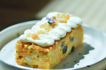 carrot cake with almond and cream topping , almond cake