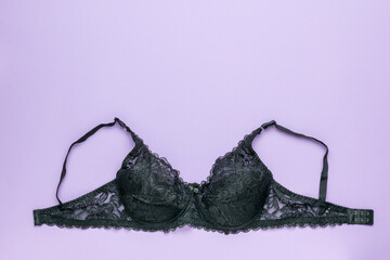 Black women's bra on a purple background. Space for text.