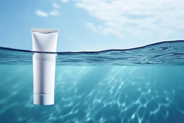 White blank cosmetic bottle tube mock up lies on the water surface