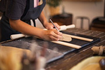 Hands of girl works with clay in modern pottery workshop. The pr