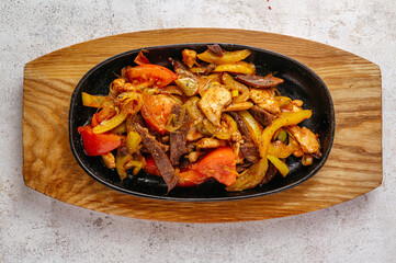 beef with vegetables fried in Asian style served in a frying pan