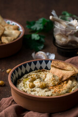 Close up hummus dip on brown table