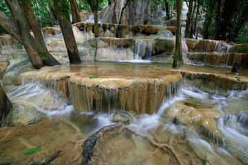 Naklejka premium Scenic view of waterfall in forest