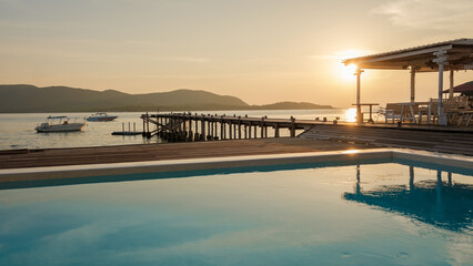 swimming pool and wooden pier in the ocean during sunset in Samaesan Thailand. - obrazy, fototapety, plakaty
