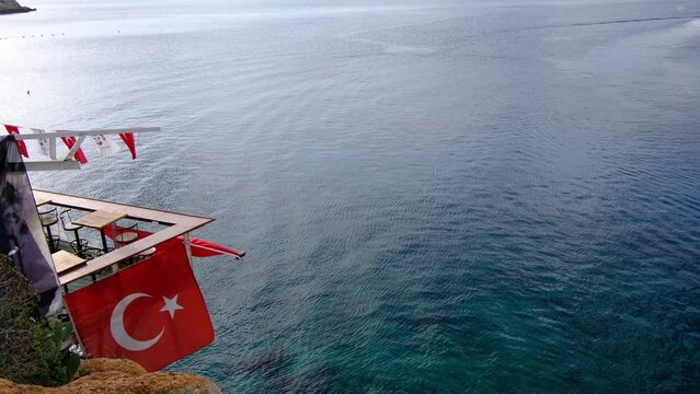 coastal cafe with beautiful large Turkish flag, picturesque haven where azure waters meet coastal serenity,