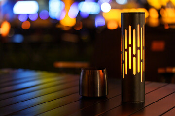 A retro orange table lamp is placed on the dining table in a restaurant.
