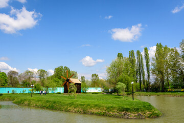 Small lake with a woodmill and an island from Chindiei Park (Parcul Chindiei) in Targoviste,...