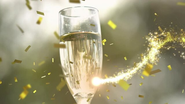 Animation of shooting stars and confetti falling over close up of hand holding a champagne glass