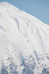 Fototapeta na wymiar Summit of snow covered Mount Yotei volcano, Niseko