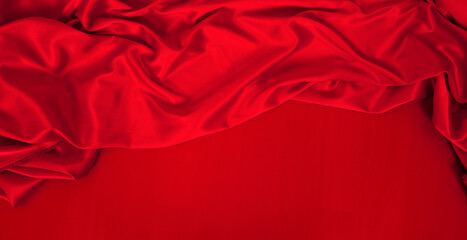 luxury red cloth or liquid wave or wavy folds of grunge silk texture satin velvet material or...
