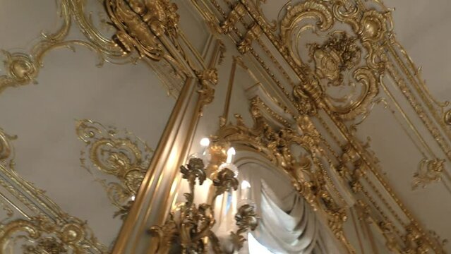 Interior of the palace is decorated with old mirrors and gilding. Vintage wall of the royal time.
