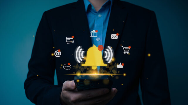 Businessman using smart phone with virtual bell ring notification alert, application notification push alert,New email, reminder trend market, digital marketing.
