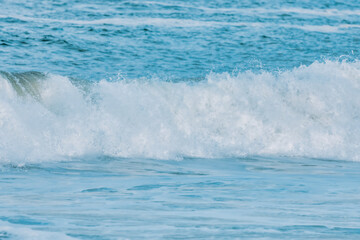Wave splashing close-up. Crystal clear sea water, in the ocean in San Francisco Bay, blue water, pastel colors.