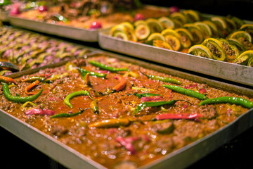 Spicy minced meat dish garnished with peppers, ready to serve. Showcases the global love for bold...