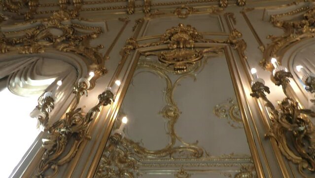 Interior of the palace is decorated with old mirrors and gilding. Vintage wall of the royal time.