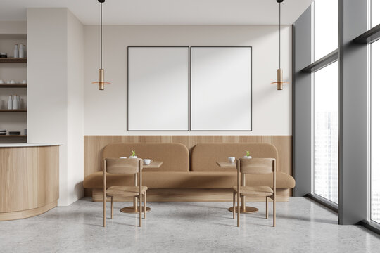 White restaurant interior with sofas and poster