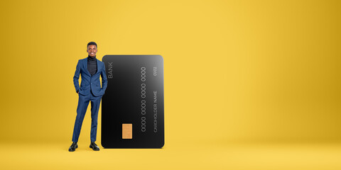 Happy African businessman with big credit card
