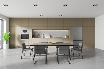 Beige kitchen interior with cabinet and eating table, cooking space and window