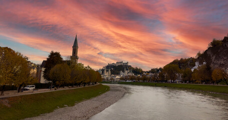 Autumn season at a historic city of Salzburg with Salzach river in beautiful sunset sky and...
