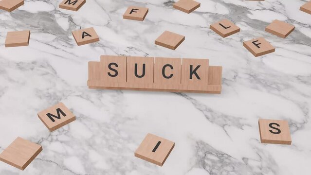 Suck word written on scrabble