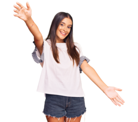Young hispanic woman wearing casual clothes looking at the camera smiling with open arms for hug. cheerful expression embracing happiness.