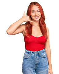 Fototapeta premium Young redhead woman wearing casual clothes smiling doing phone gesture with hand and fingers like talking on the telephone. communicating concepts.