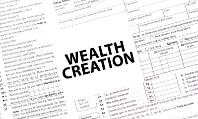 WEALTH CREATION on white sticker with tax forms