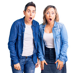 Couple of women wearing casual clothes afraid and shocked with surprise and amazed expression, fear...