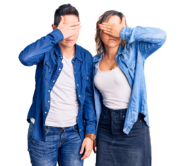 Couple of women wearing casual clothes covering eyes with hand, looking serious and sad. sightless, hiding and rejection concept
