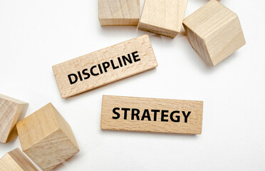 discipline strategy on wooden blocks on white background