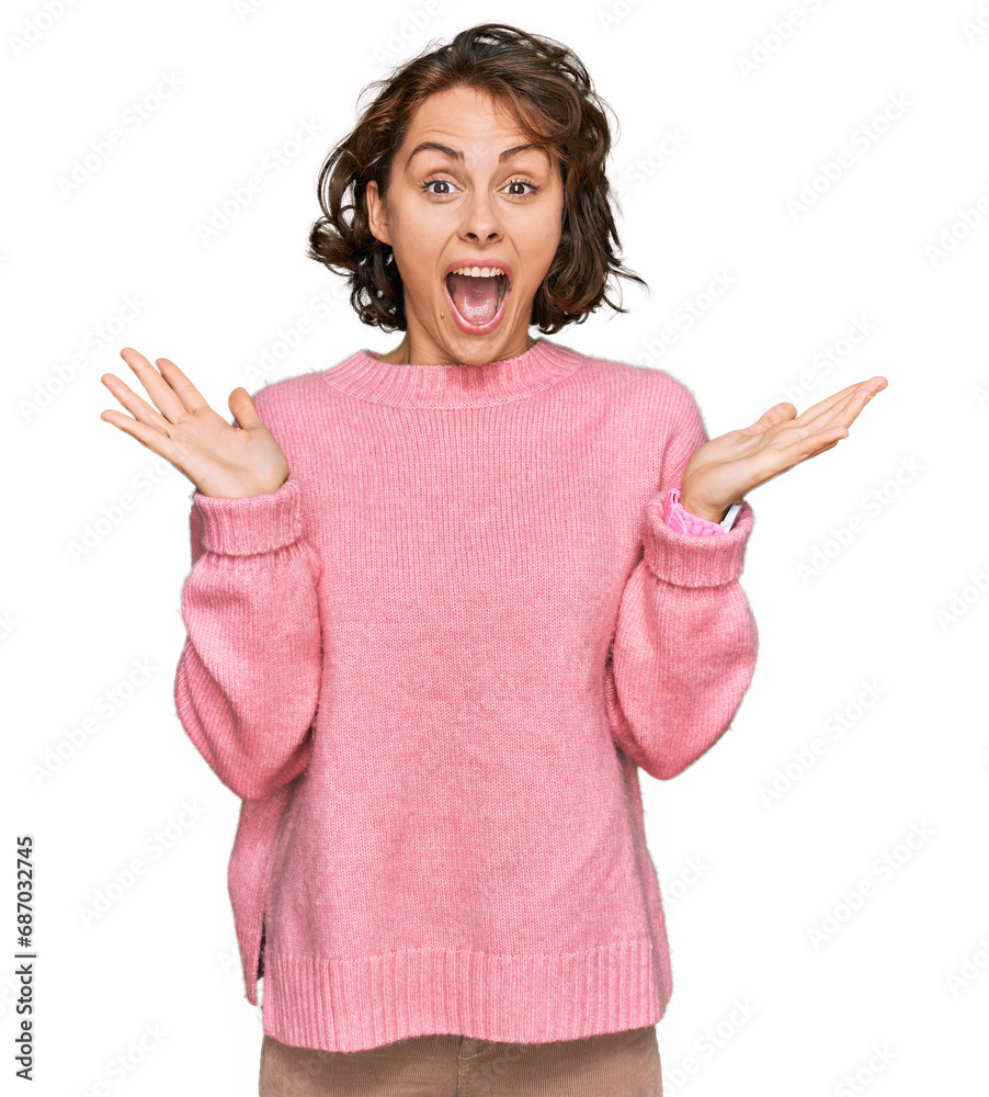 Poster Young hispanic woman wearing casual clothes celebrating crazy and amazed for success with arms raised and open eyes screaming excited. winner concept