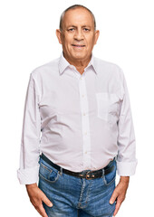 Handsome senior man wearing elegant white shirt with a happy and cool smile on face. lucky person.