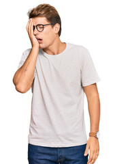 Handsome caucasian man wearing casual clothes and glasses yawning tired covering half face, eye and mouth with hand. face hurts in pain.
