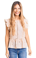 Obraz premium Beautiful caucasian woman with blonde hair wearing elegant summer clothes looking positive and happy standing and smiling with a confident smile showing teeth