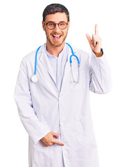 Handsome young man with bear wearing doctor uniform pointing finger up with successful idea. exited and happy. number one.