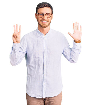 Handsome young man with bear wearing elegant business shirt and glasses showing and pointing up with fingers number eight while smiling confident and happy.