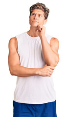 Young handsome man wearing sleveeless t shirt serious face thinking about question with hand on...